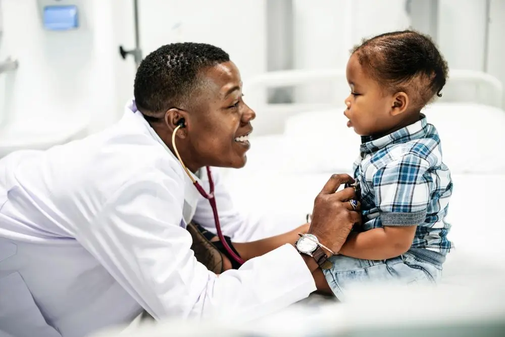 doctor examining toddler