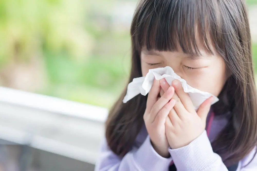 girl blowing nose